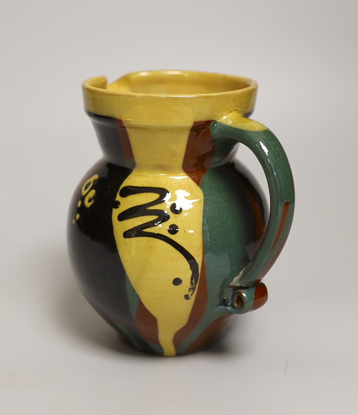 Margaret Brompton studio pottery bowl with insects, together with a slipware jug, a Longpark, Torquay small cockerel jug, and a Susan Juniper slipware jug, largest 21cm diameter, (4)